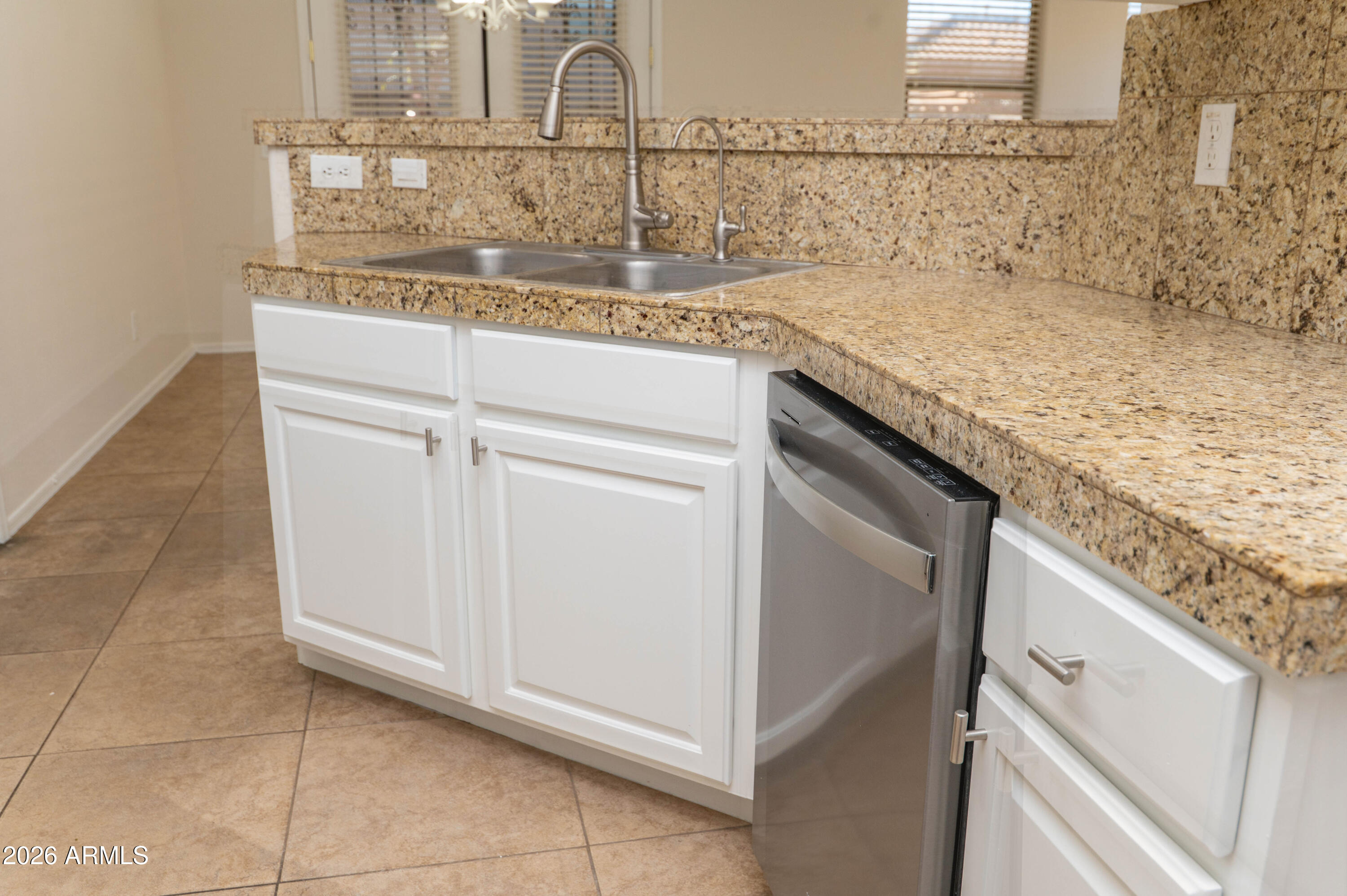 45633 West Mountain View Road Maricopa, AZ 85139 - Photo 20 of 78 a kitchen with granite countertop white cabinets and a sink