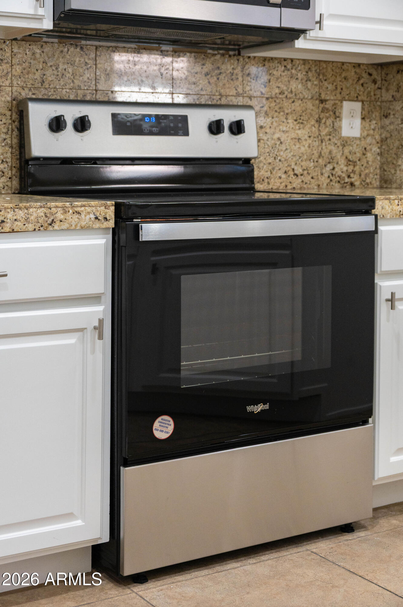 45633 West Mountain View Road Maricopa, AZ 85139 - Photo 27 of 78 a stove top oven sitting inside of a kitchen