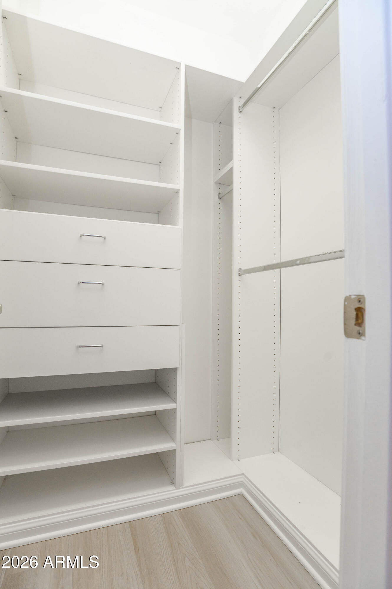 45633 West Mountain View Road Maricopa, AZ 85139 - Photo 37 of 78 a view of walk in closet with empty racks