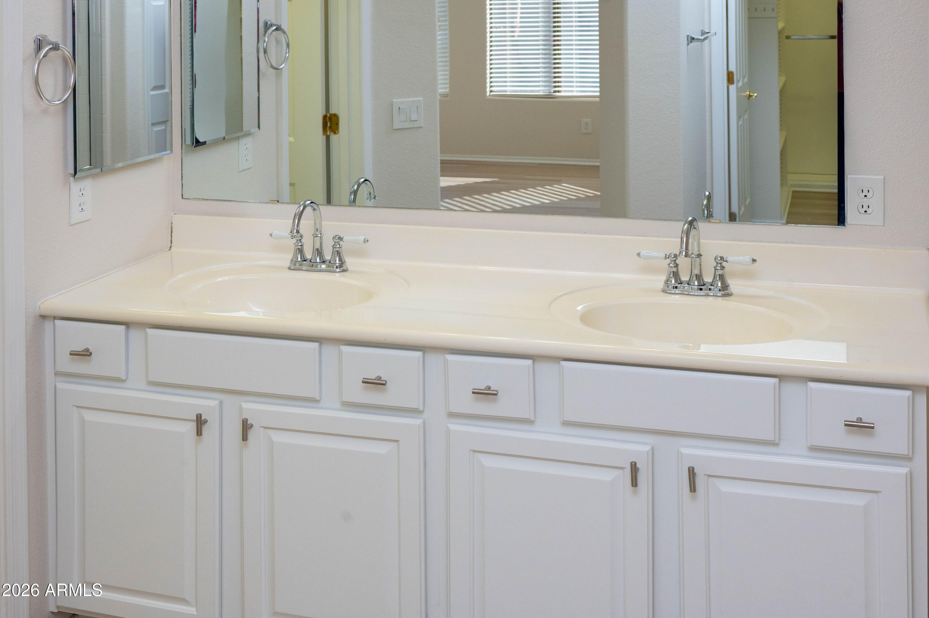 45633 West Mountain View Road Maricopa, AZ 85139 - Photo 38 of 78 a bathroom with a sink and a mirror