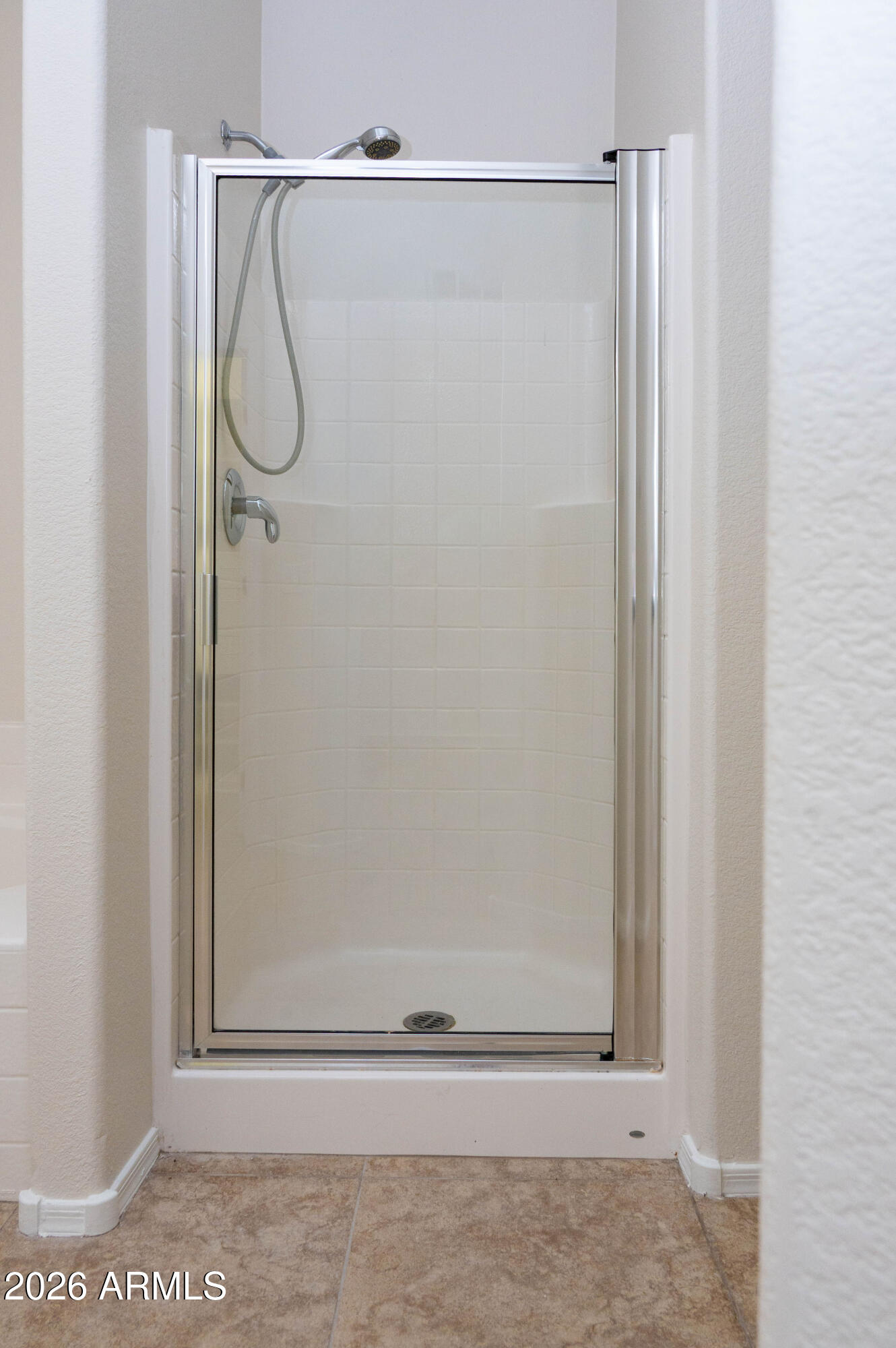 45633 West Mountain View Road Maricopa, AZ 85139 - Photo 44 of 78 a bathroom with a glass shower door