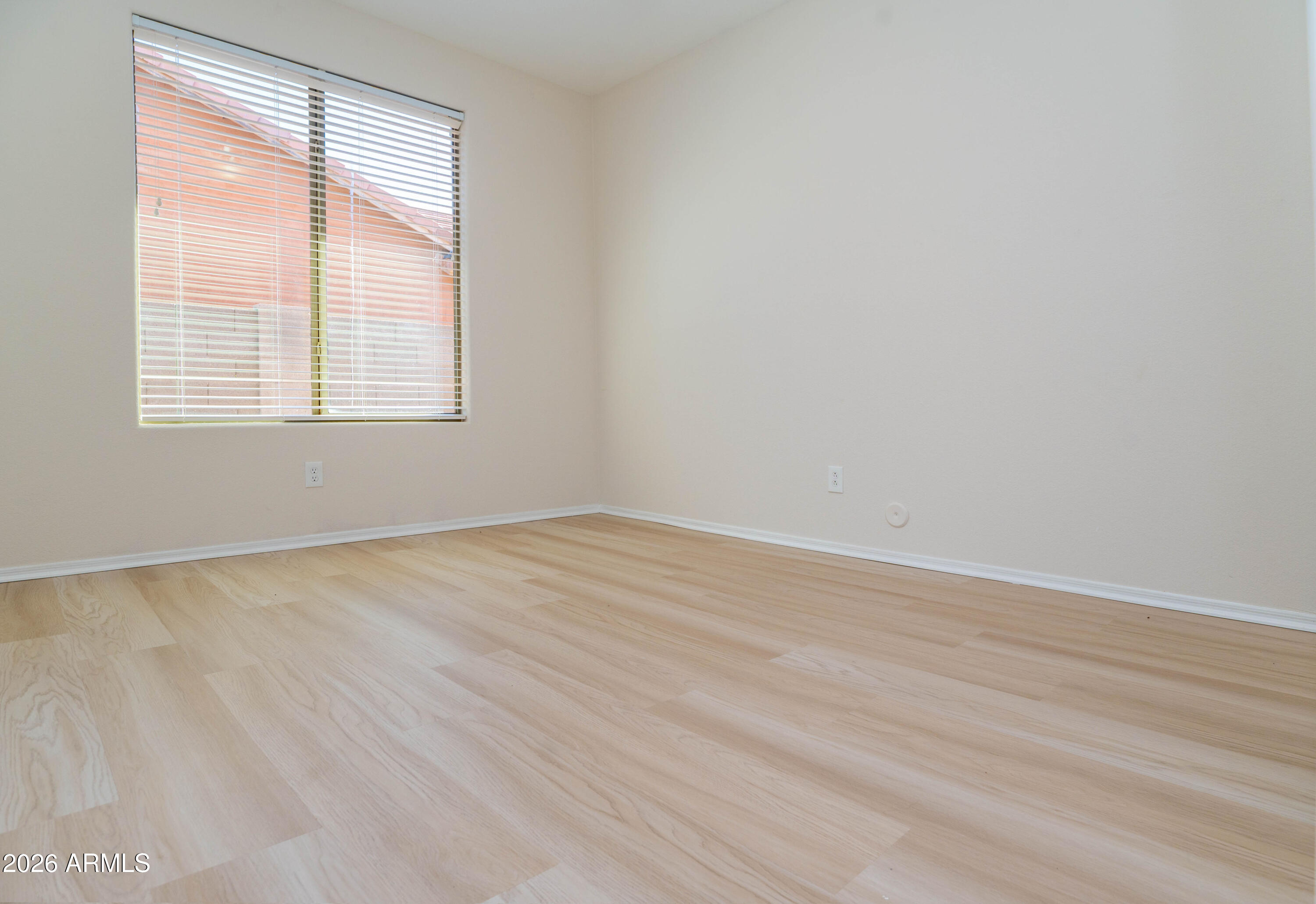 45633 West Mountain View Road Maricopa, AZ 85139 - Photo 46 of 78 wooden floor in an empty room with a window