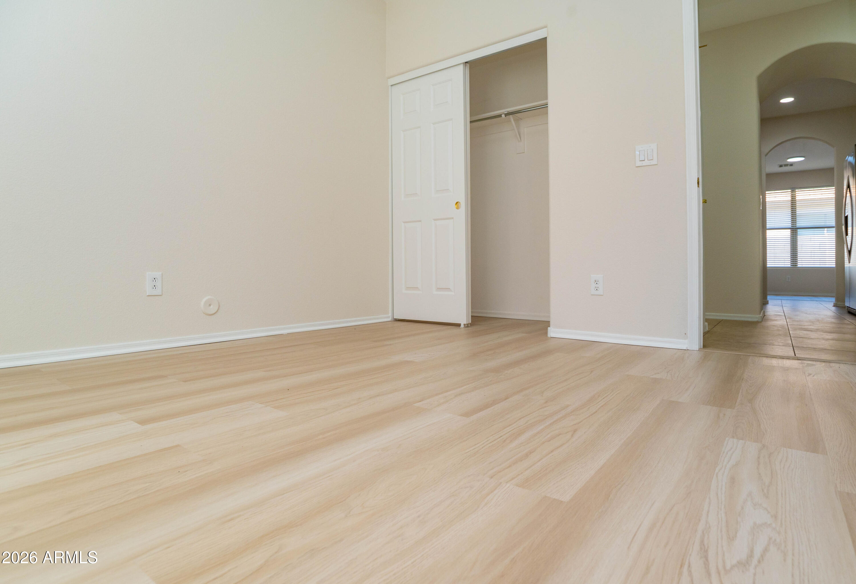 45633 West Mountain View Road Maricopa, AZ 85139 - Photo 47 of 78 a view of an empty room with wooden floor and a window