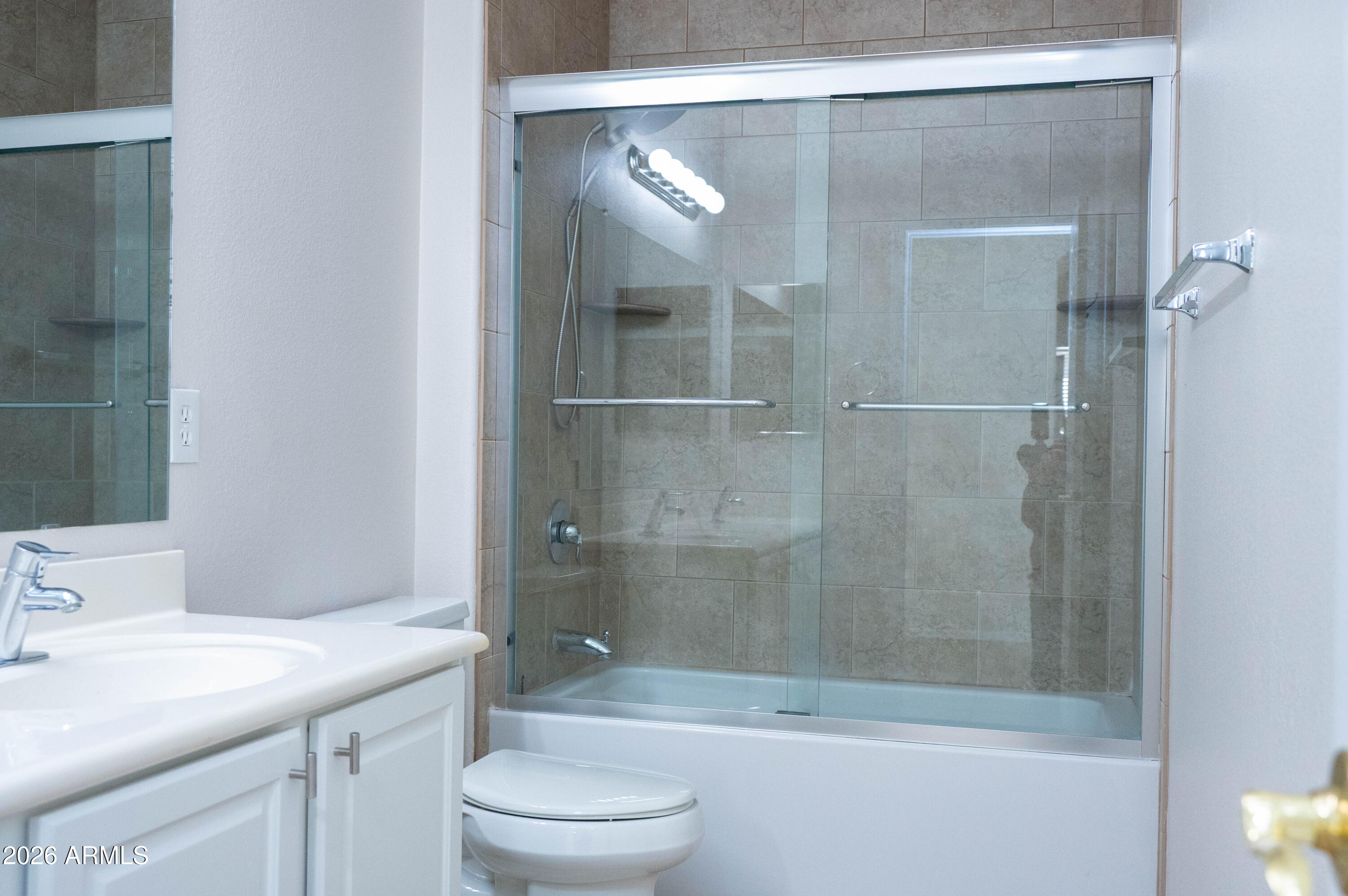 45633 West Mountain View Road Maricopa, AZ 85139 - Photo 50 of 78 a bathroom with a shower a toilet and sink