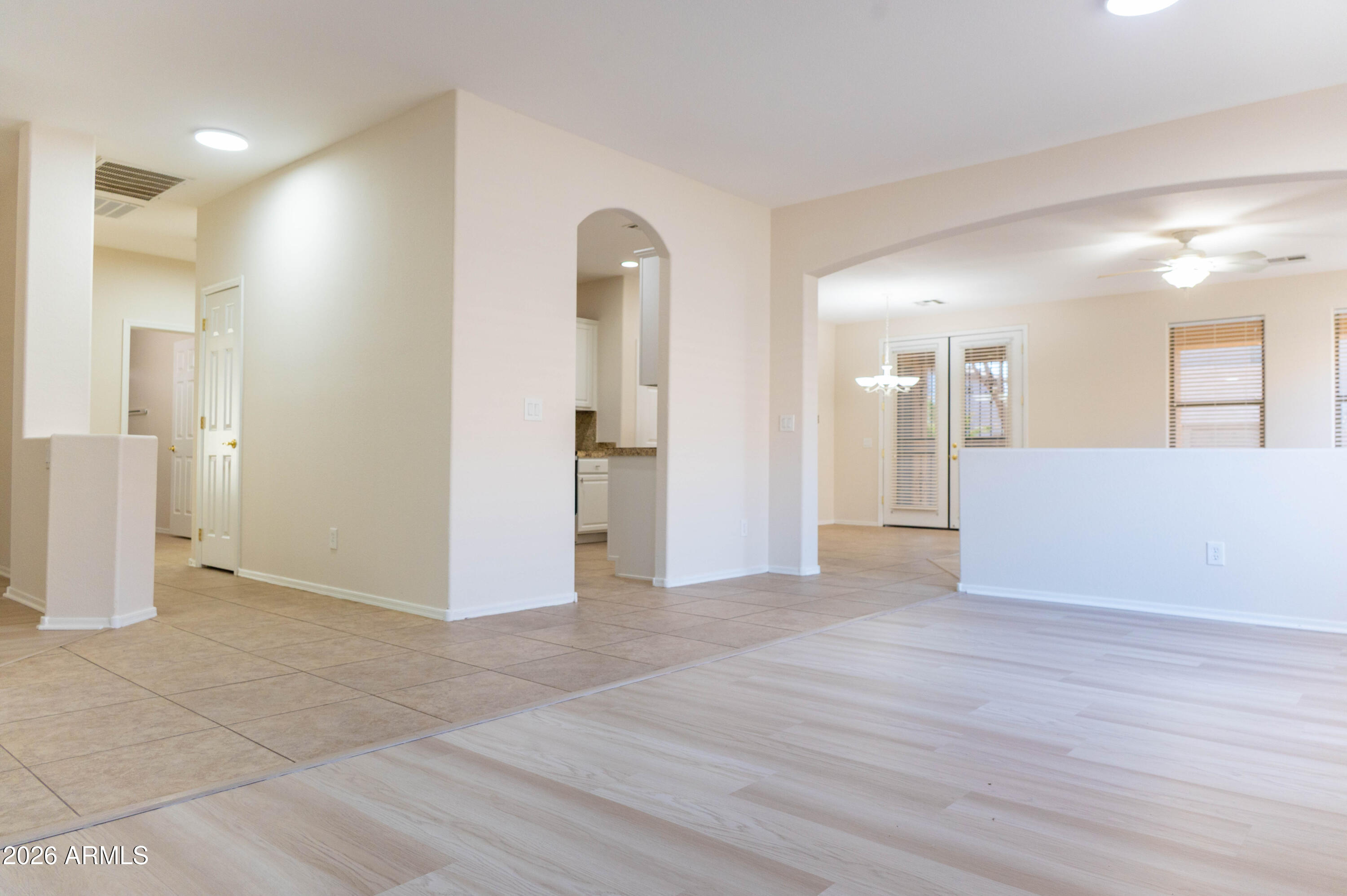 45633 West Mountain View Road Maricopa, AZ 85139 - Photo 8 of 78 a view of a big room with wooden floor and a bathroom