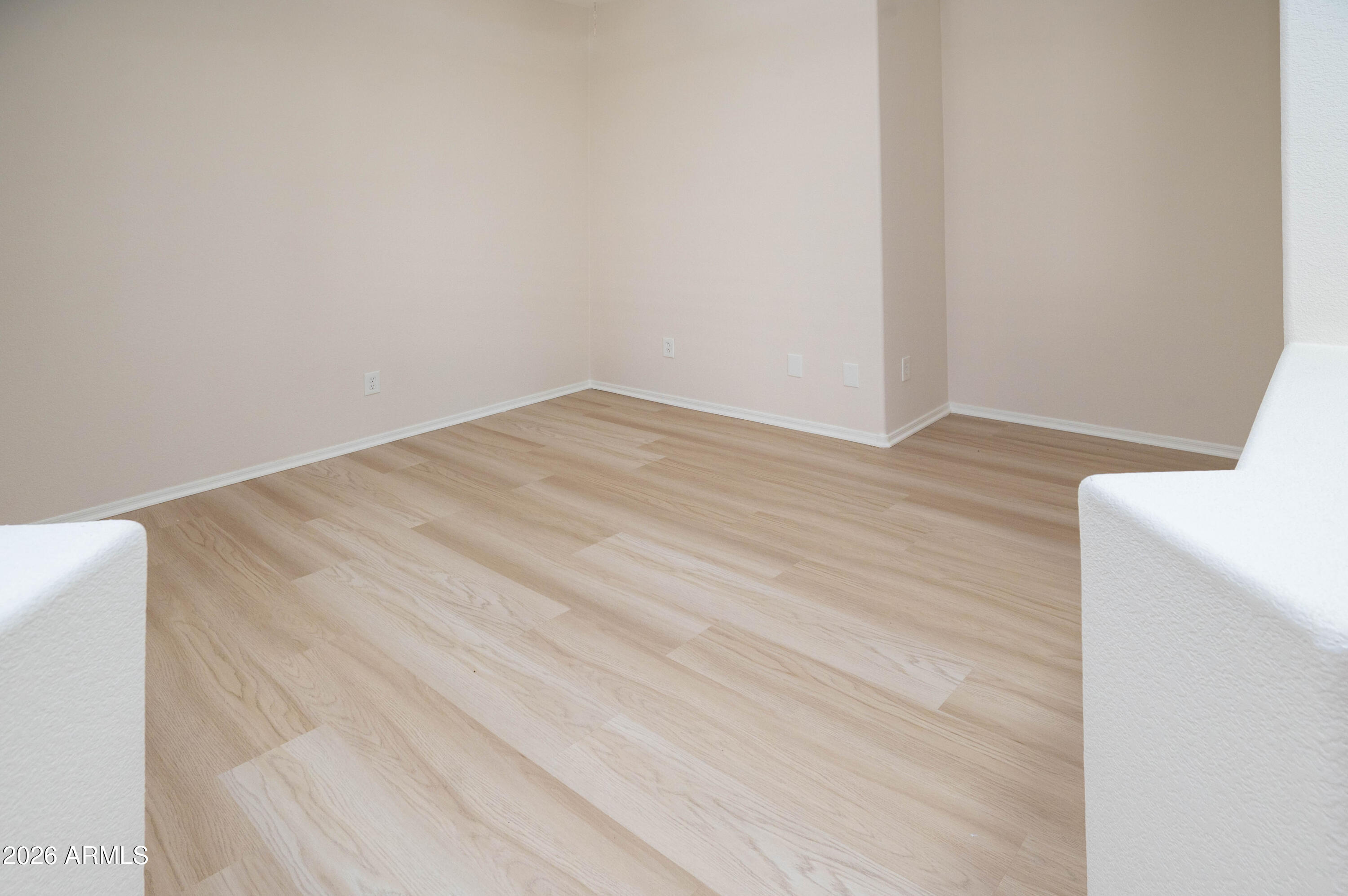45633 West Mountain View Road Maricopa, AZ 85139 - Photo 9 of 78 a view of empty room with wooden floor