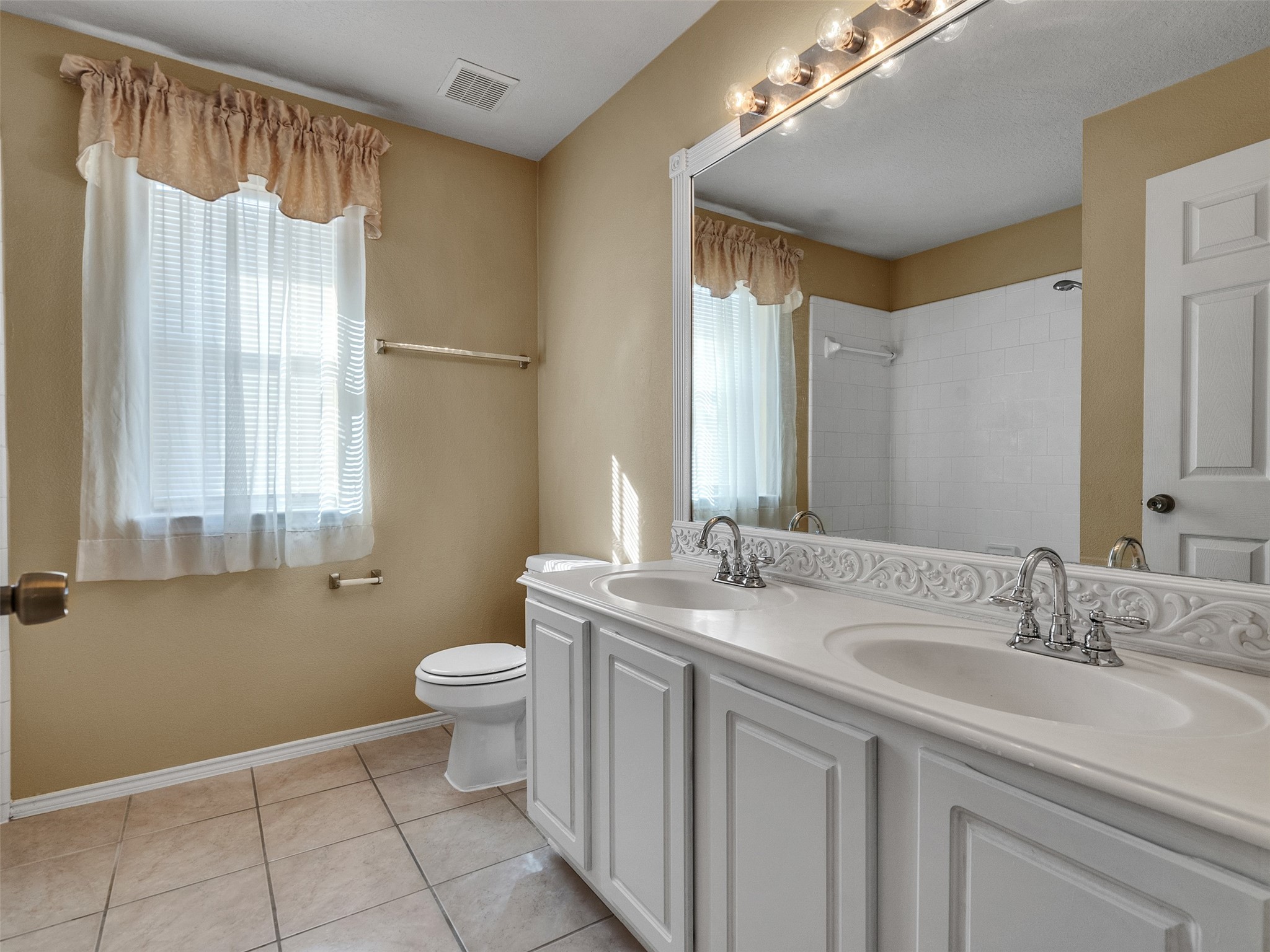 4815 Cottage Stone Lane Katy, TX 77449 - Photo 34 of 48 a bathroom with a double vanity sink toilet and a mirror
