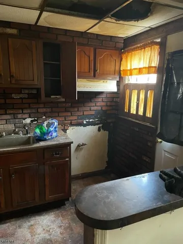 a kitchen with granite countertop a sink and a stove