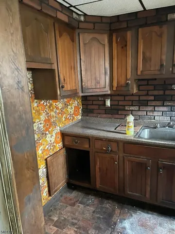 a view of a big room with wooden floor and windows