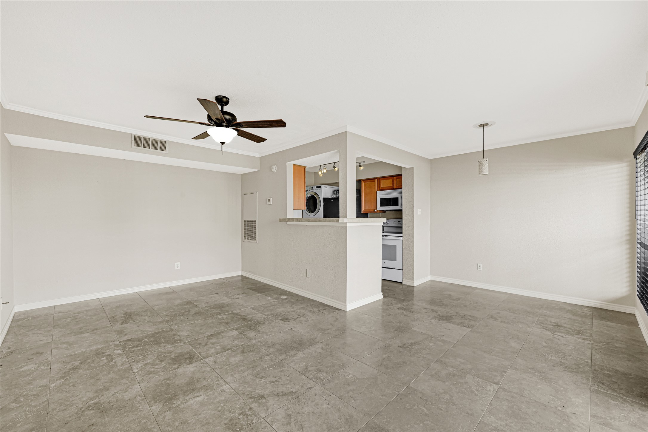 4011 NASA Road 1, Unit 406 El Lago, TX 77586 - Photo 7 of 23 a view of a livingroom with a kitchen space with a sink