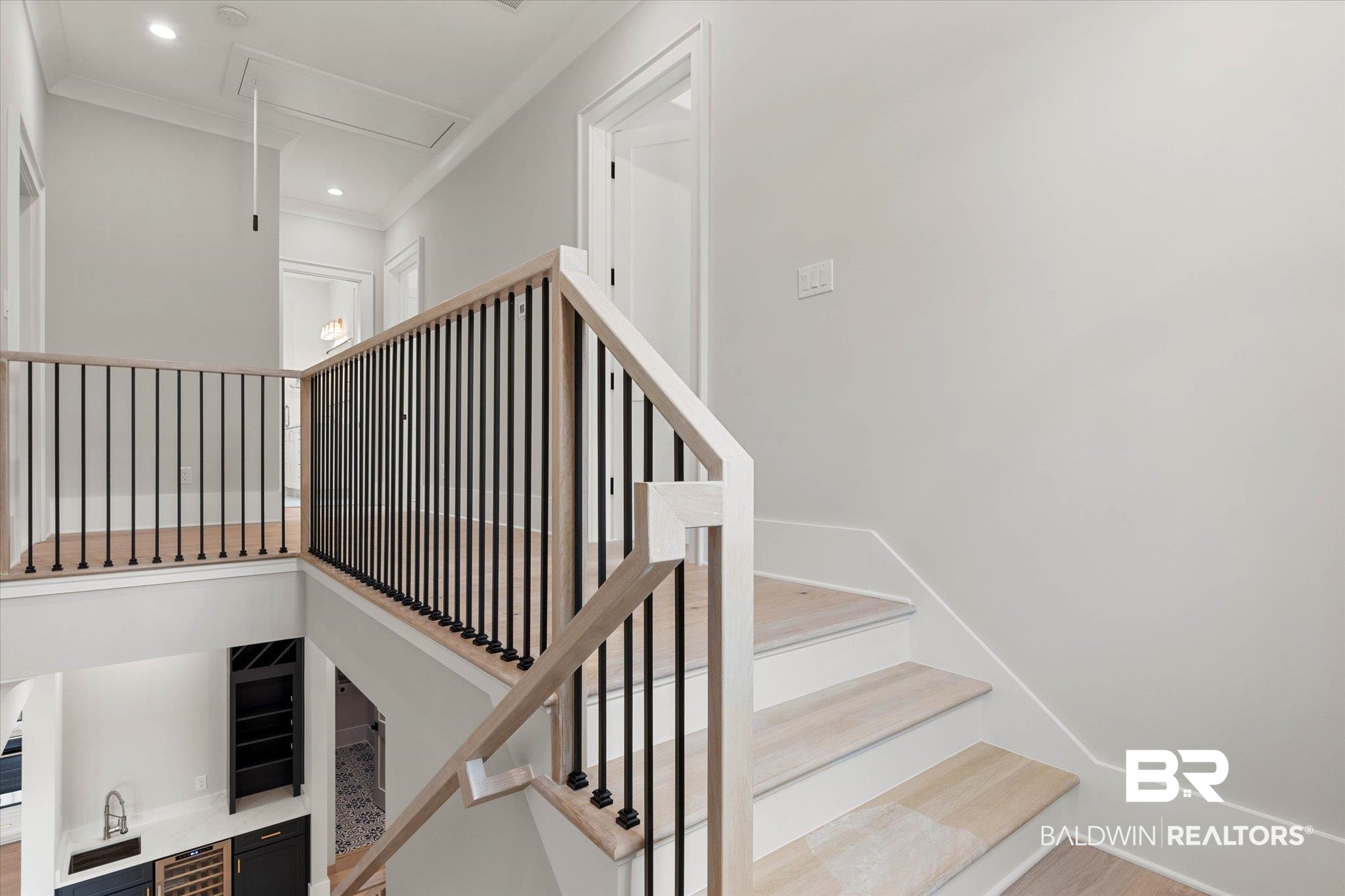 853 Inlet Circle Gulf Shores, AL 36542 - Photo 26 of 55 Staircase with recessed lighting, ornamental molding, attic access, and wine cooler