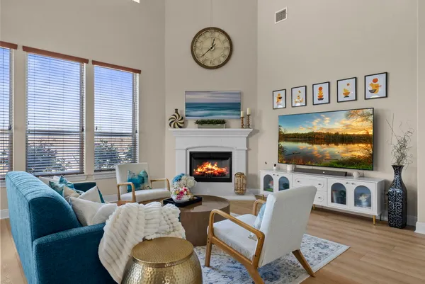 a living room with furniture a fireplace and a table
