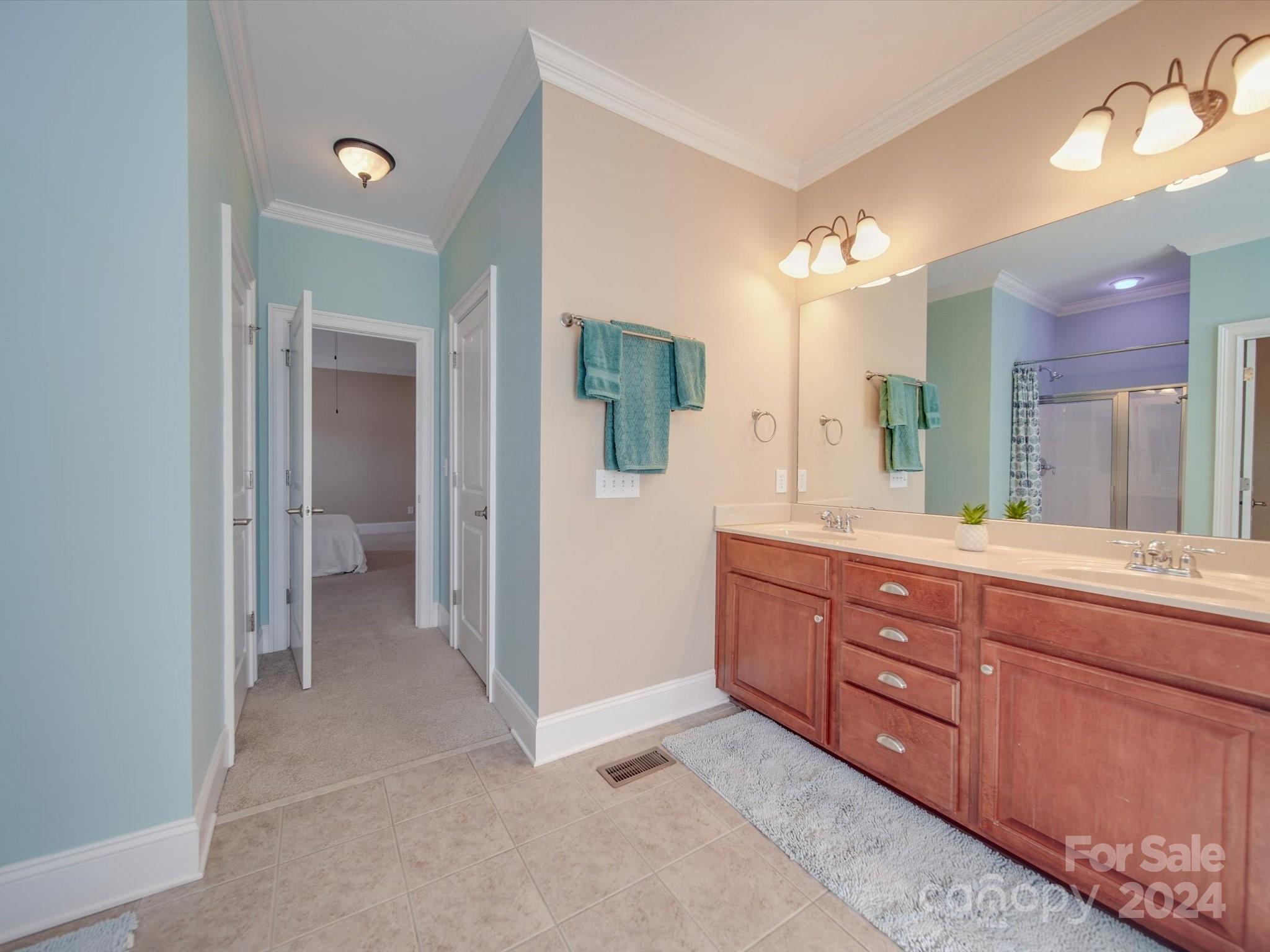 19617 Coachmans Trace Cornelius, NC 28031 - Photo 12 of 46 a spacious bathroom with a granite countertop sink and a mirror