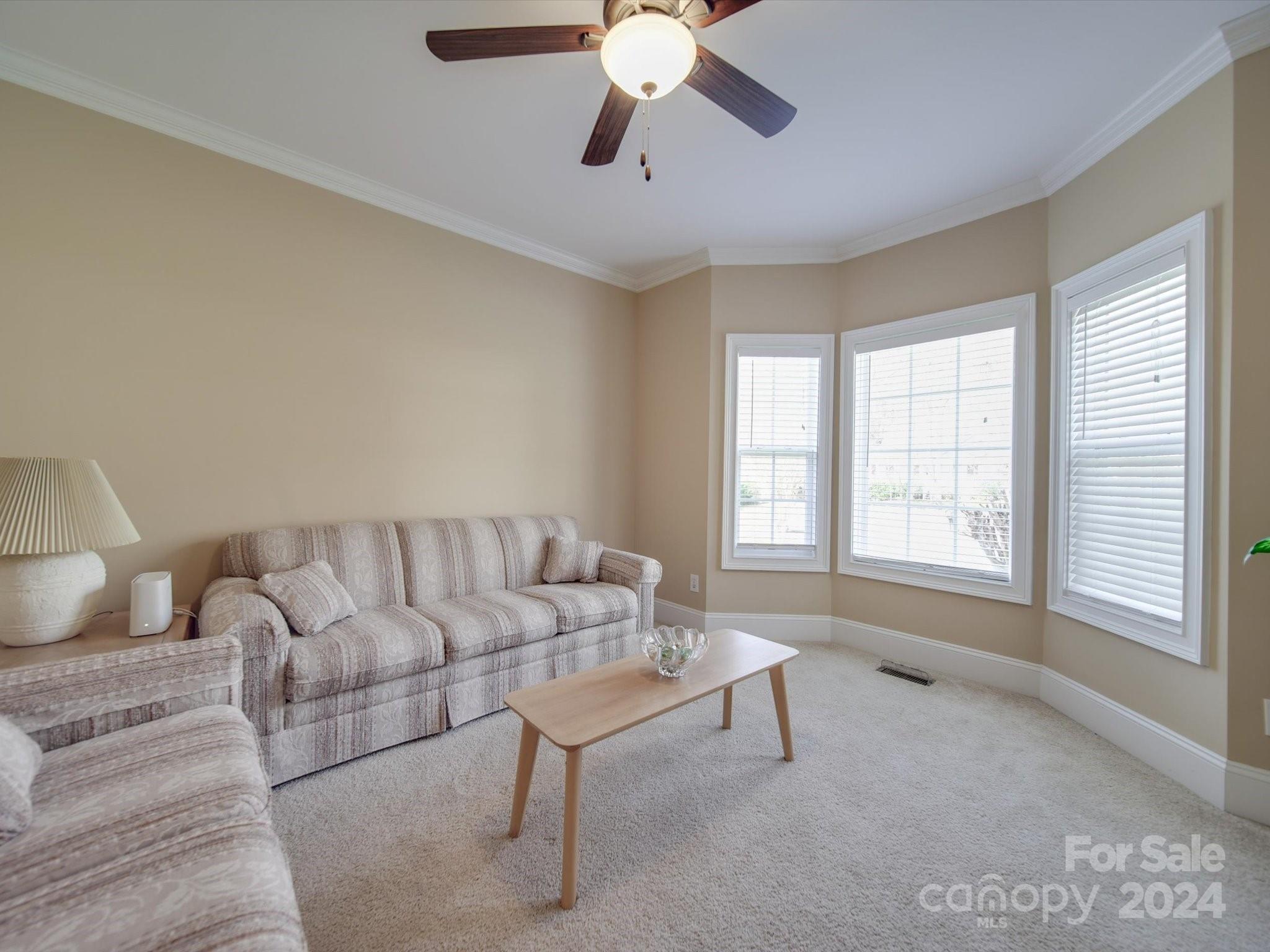 19617 Coachmans Trace Cornelius, NC 28031 - Photo 16 of 46 a living room with furniture and a large window