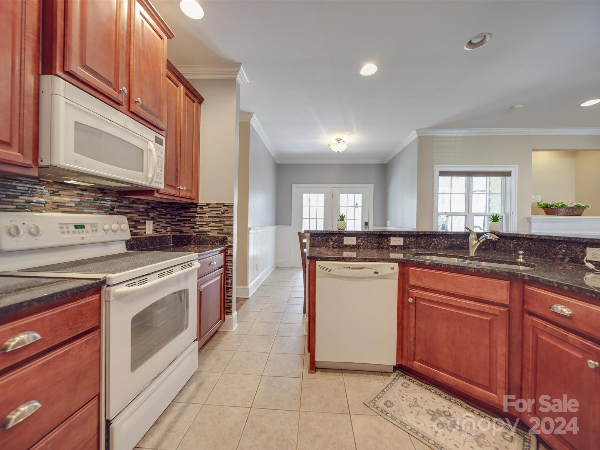 19617 Coachmans Trace Cornelius, NC 28031 - Photo 19 of 46 a kitchen with stainless steel appliances granite countertop a stove sink and cabinets