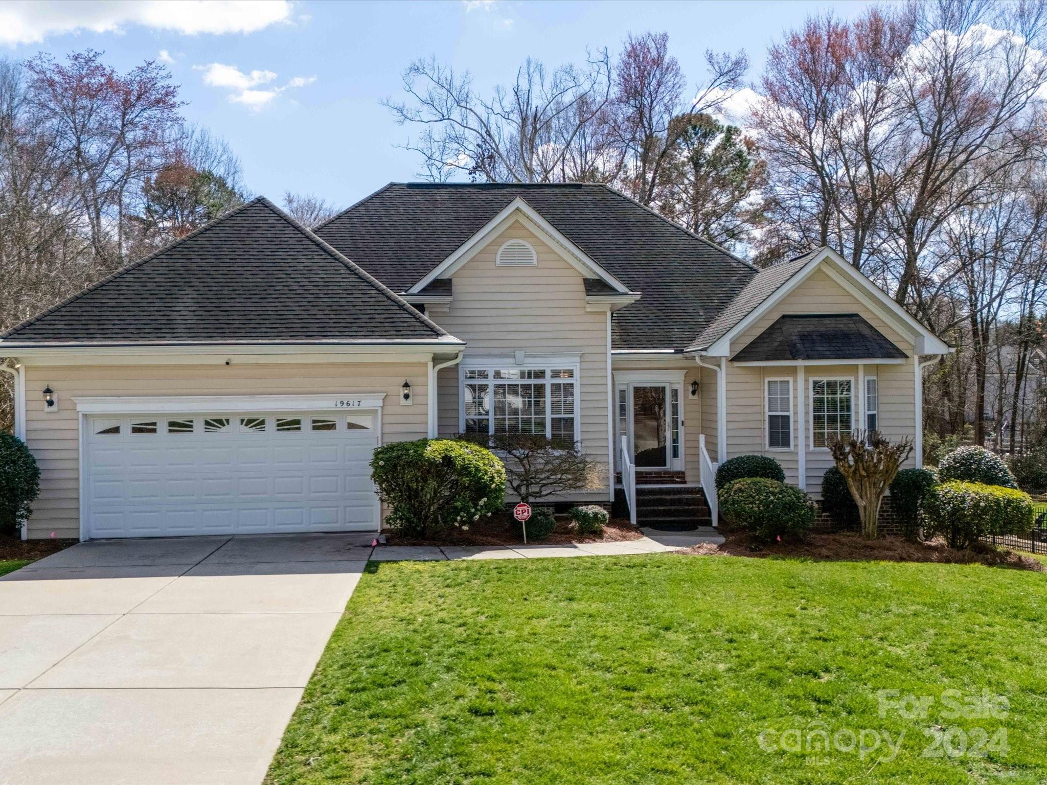 19617 Coachmans Trace Cornelius, NC 28031 - Photo 2 of 46 a front view of a house with garden