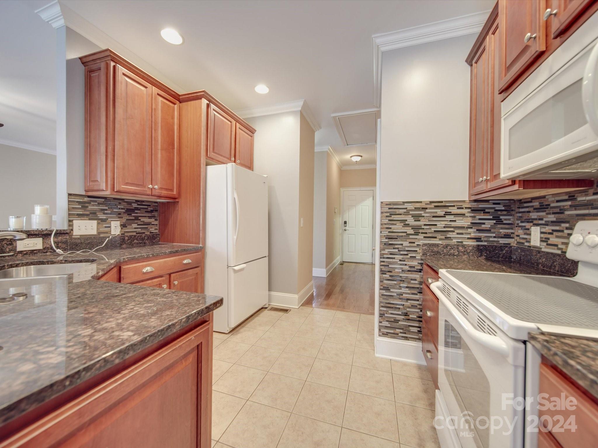 19617 Coachmans Trace Cornelius, NC 28031 - Photo 21 of 46 a kitchen with stainless steel appliances granite countertop a sink and a refrigerator