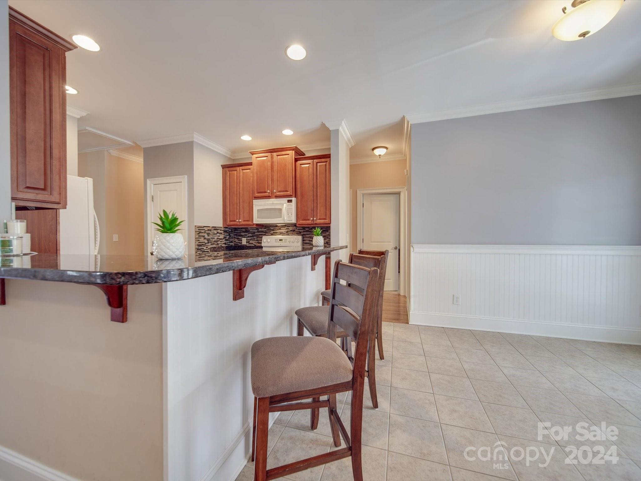 19617 Coachmans Trace Cornelius, NC 28031 - Photo 24 of 46 a kitchen with stainless steel appliances a refrigerator and a stove top oven