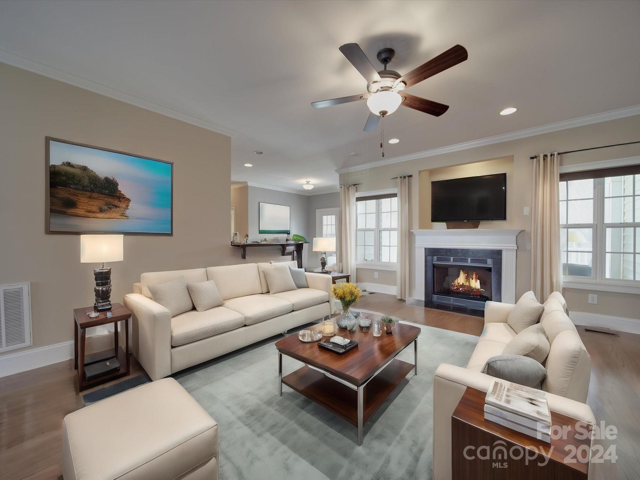 19617 Coachmans Trace Cornelius, NC 28031 - Photo 25 of 46 a living room with furniture a fireplace and a flat screen tv