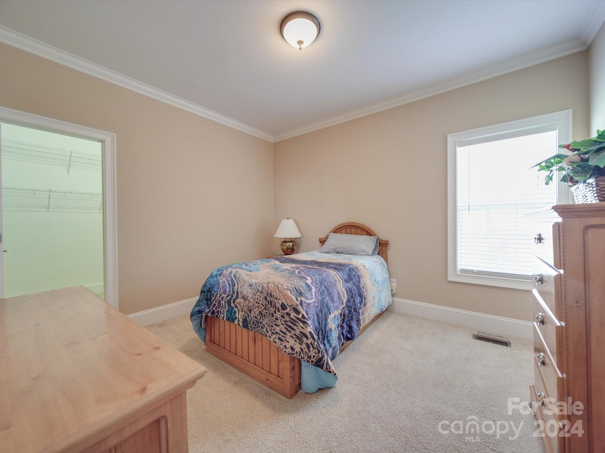 19617 Coachmans Trace Cornelius, NC 28031 - Photo 31 of 46 a spacious bedroom with a bed and a window