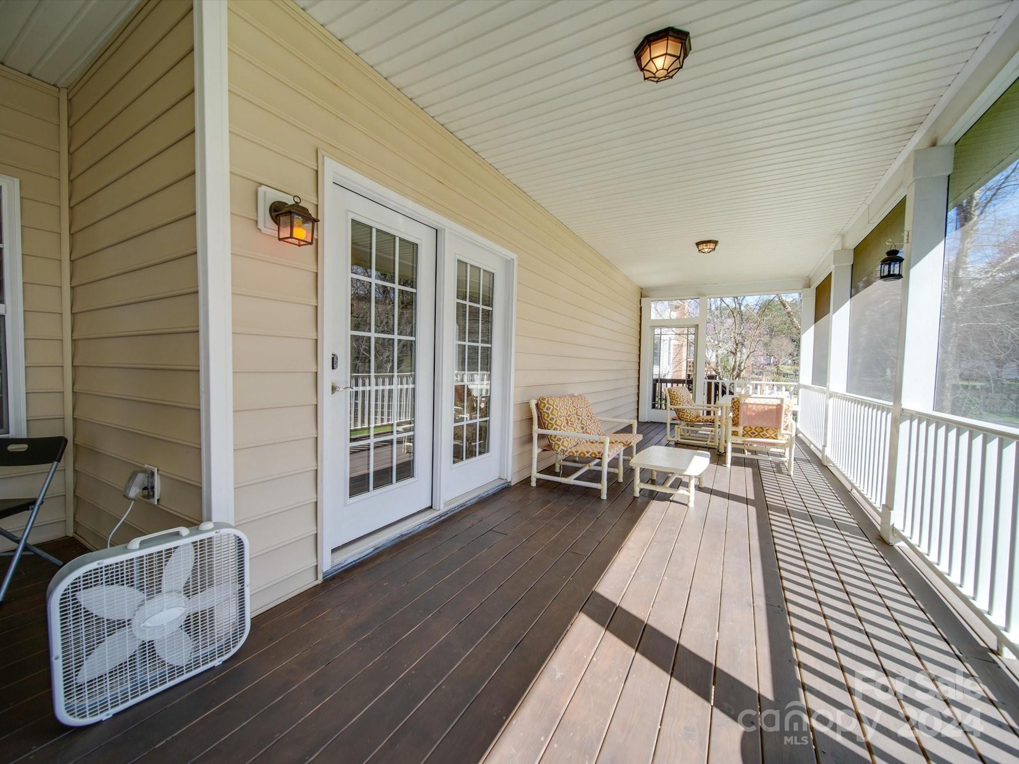 19617 Coachmans Trace Cornelius, NC 28031 - Photo 41 of 46 a view of a living room and a wooden deck
