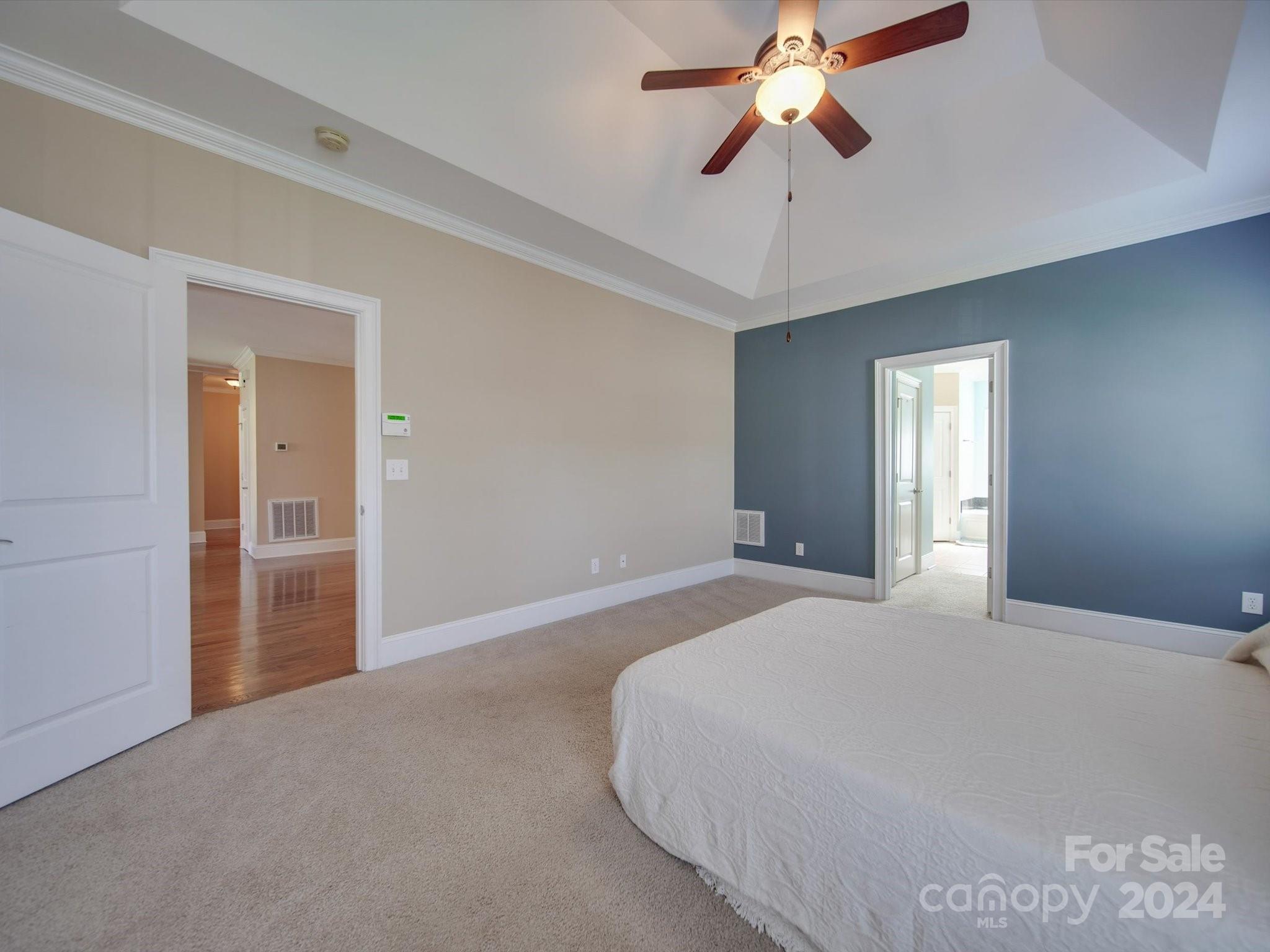 19617 Coachmans Trace Cornelius, NC 28031 - Photo 6 of 46 a bedroom with a bed and a chandelier