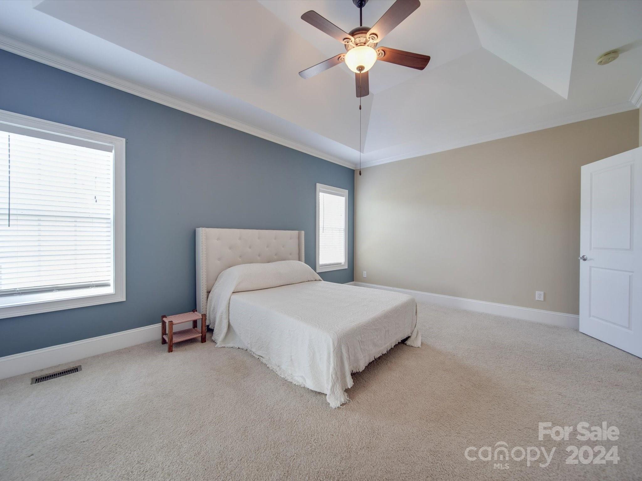 19617 Coachmans Trace Cornelius, NC 28031 - Photo 7 of 46 a bedroom with a bed and a chandelier