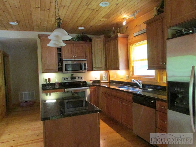 212 Cameron Terrace Boone, NC 28607 - Photo 5 of 29 a kitchen with stainless steel appliances granite countertop a sink a stove and a refrigerator