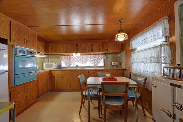 a dining room with furniture and chandelier