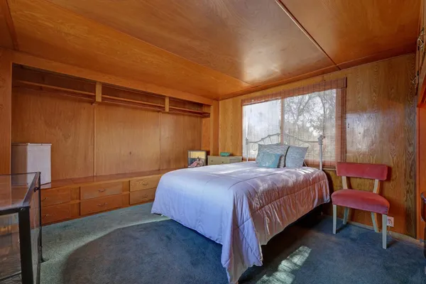 a bedroom with a bed and a window