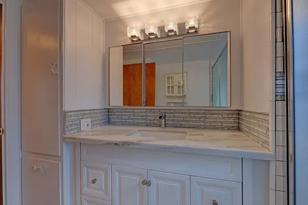 a bathroom with a sink and a mirror