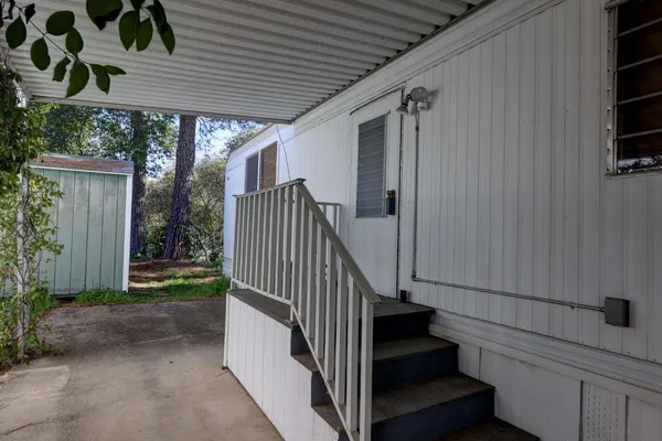 a view of a porch with wooden floor and stairs