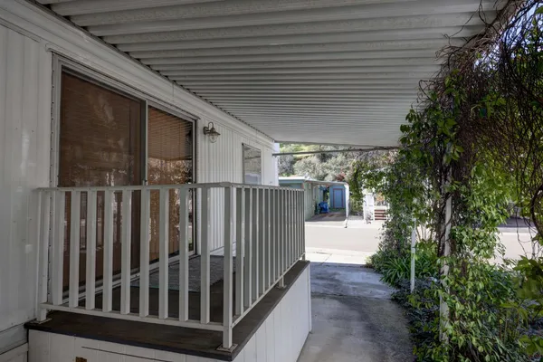 a view of a porch with wooden floor and fence