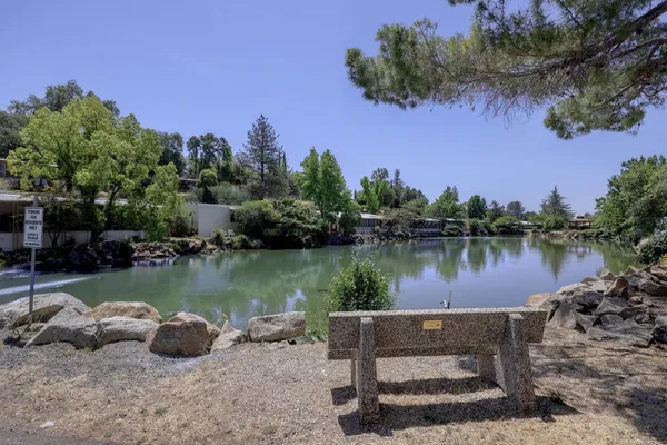 a view of a lake with a table and a chairs