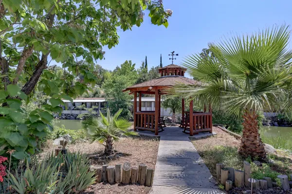 a backyard of a house with yard and outdoor seating