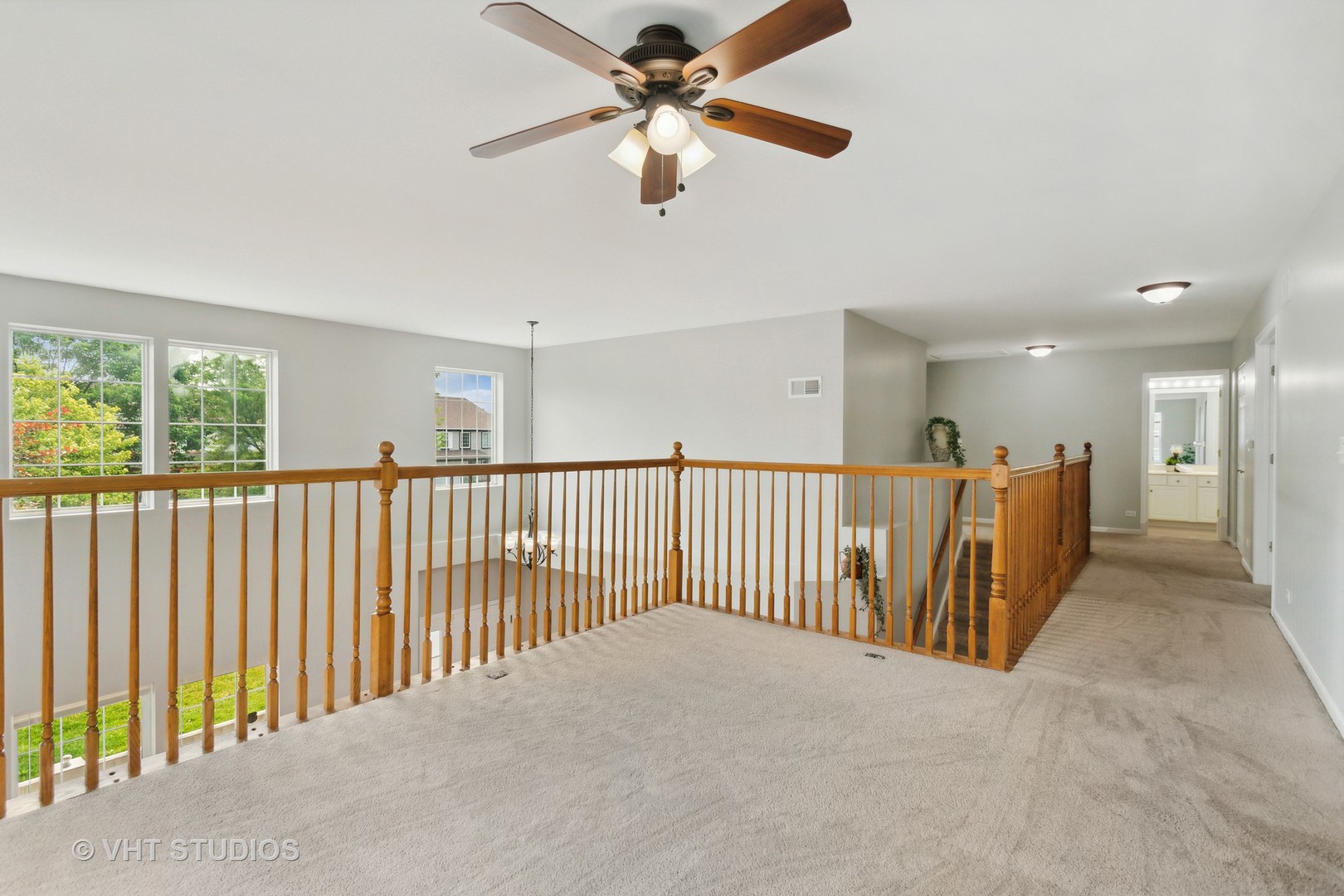 823 Fieldcrest Drive Naperville, IL 60540 - Photo 13 of 30 a view of a hallway with a ceiling fan and windows