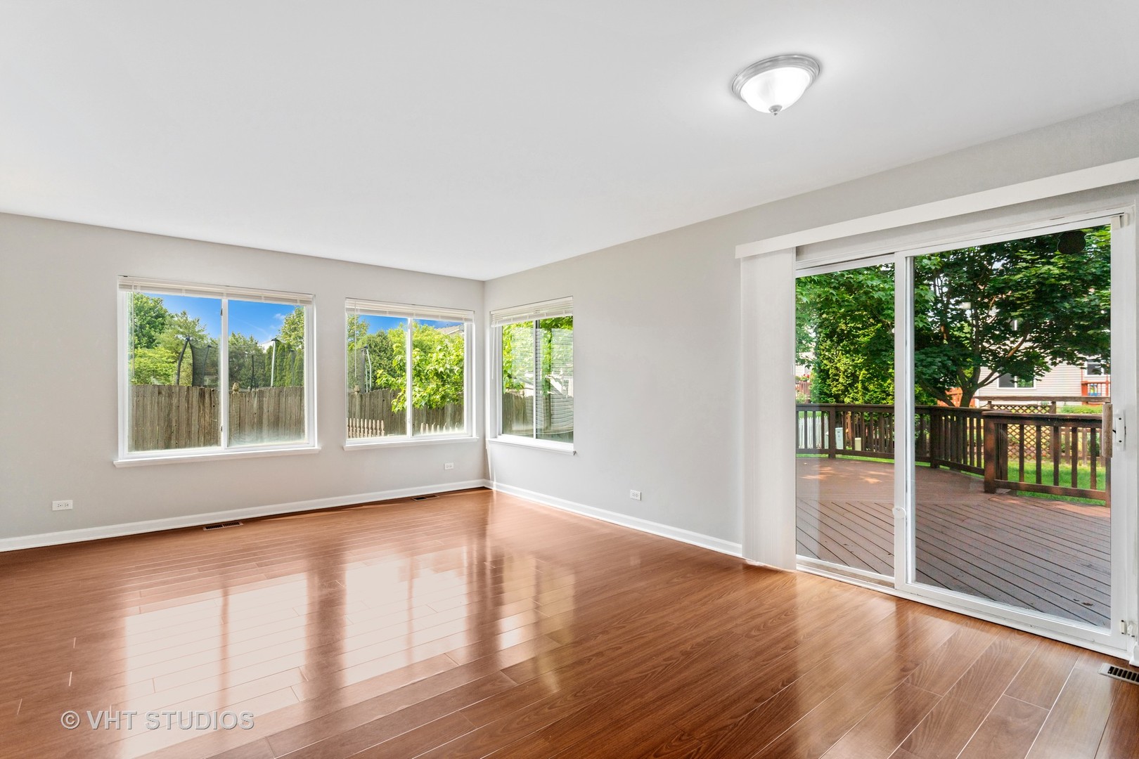 823 Fieldcrest Drive Naperville, IL 60540 - Photo 14 of 30 a view of an empty room with wooden floor and a large window