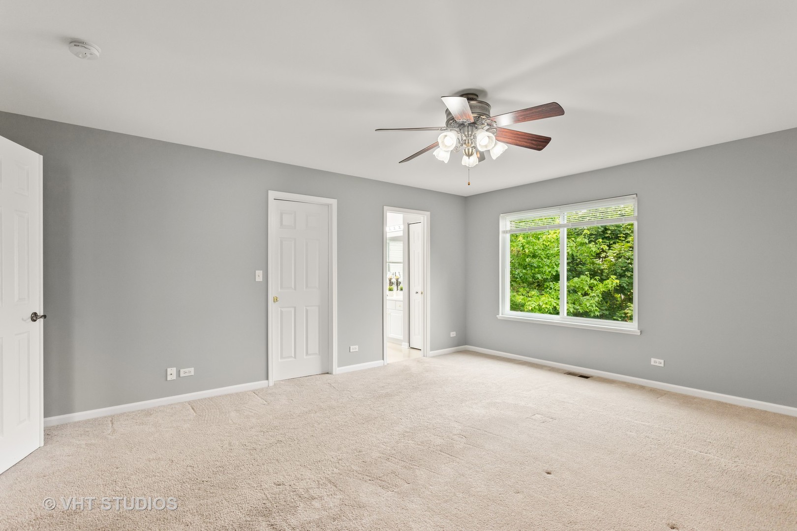 823 Fieldcrest Drive Naperville, IL 60540 - Photo 15 of 30 a view of a room with a ceiling fan and a window
