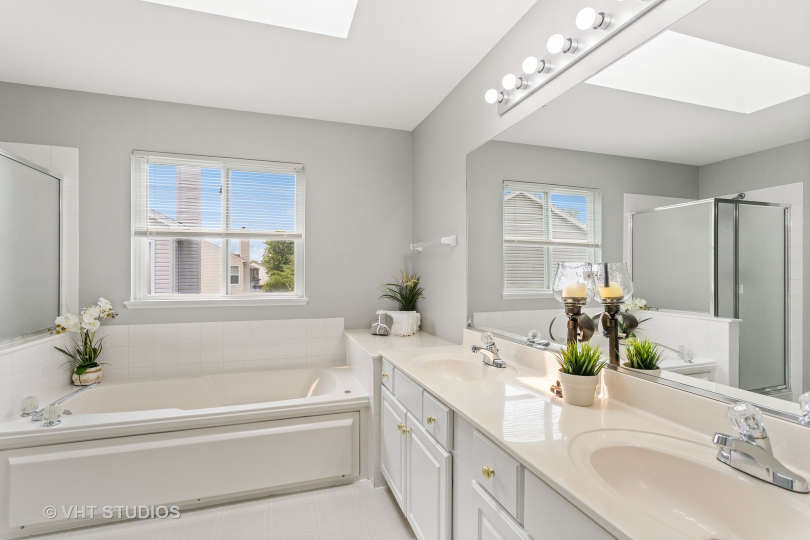 823 Fieldcrest Drive Naperville, IL 60540 - Photo 17 of 30 a bathroom with a bathtub a sink and a window