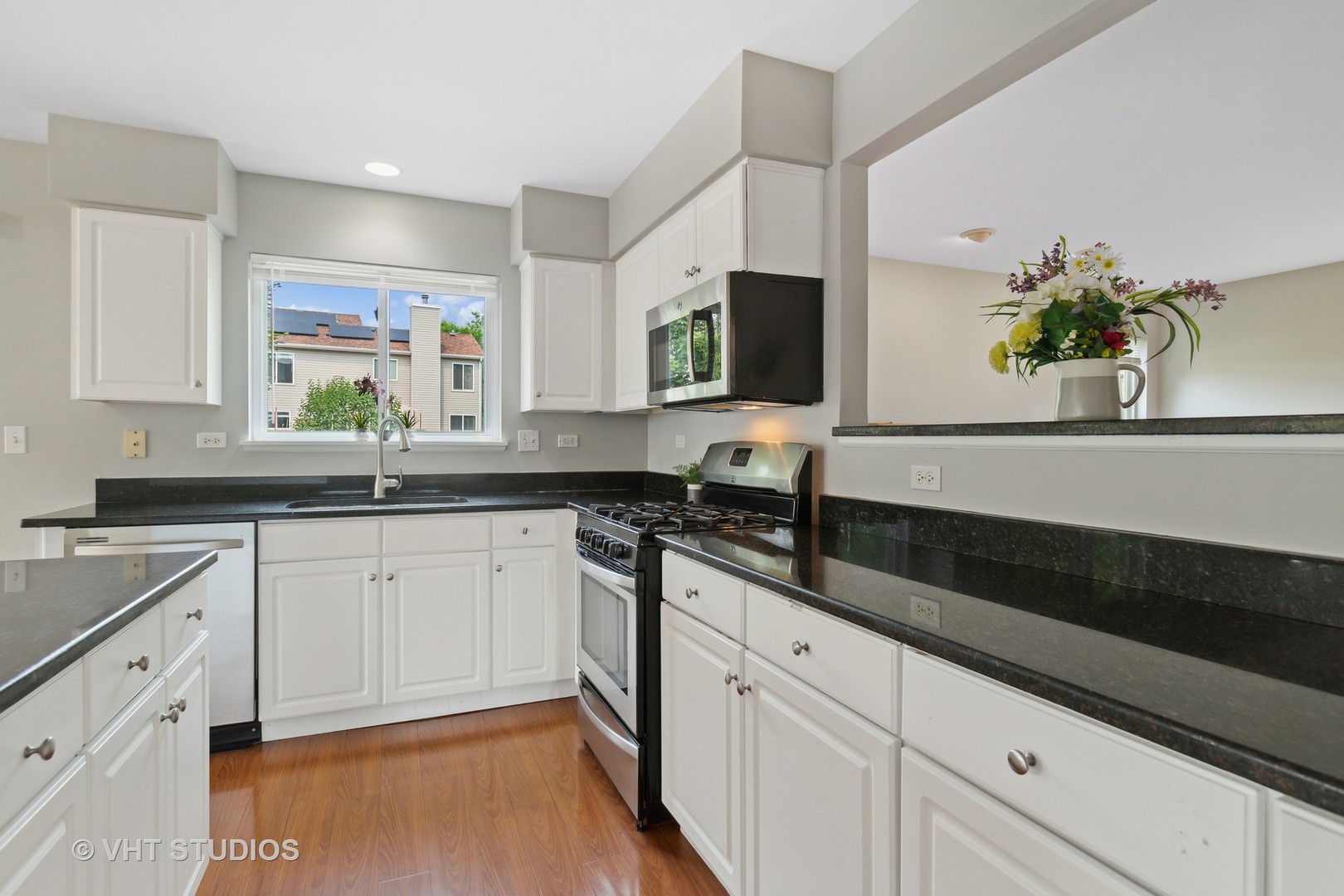 823 Fieldcrest Drive Naperville, IL 60540 - Photo 8 of 30 a kitchen with granite countertop white cabinets and a stove