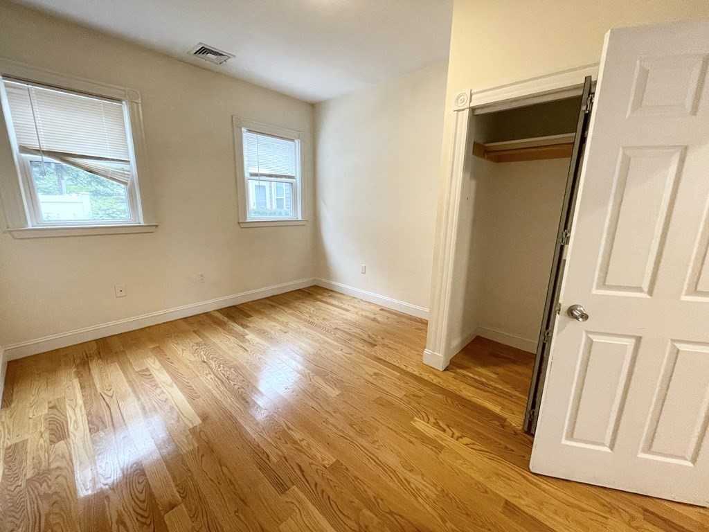 98 L Street, Unit STREET Boston, MA 02127 - Photo 7 of 19 a view of an empty room with wooden floor and a window
