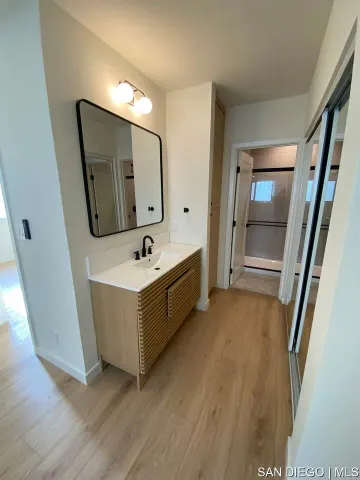 a bathroom with a double vanity sink and a mirror