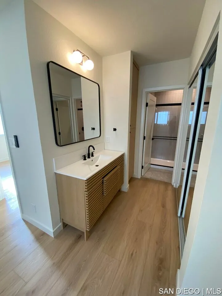 a bathroom with a double vanity sink and a mirror