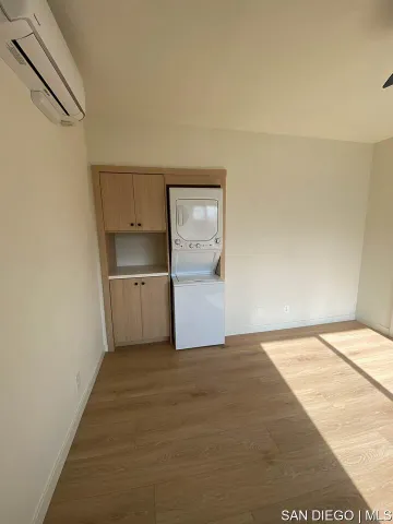 a view of a kitchen with wooden floor and electronic appliances