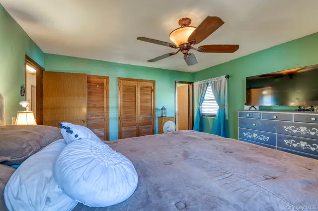 a bed room with a bed and a flat screen tv