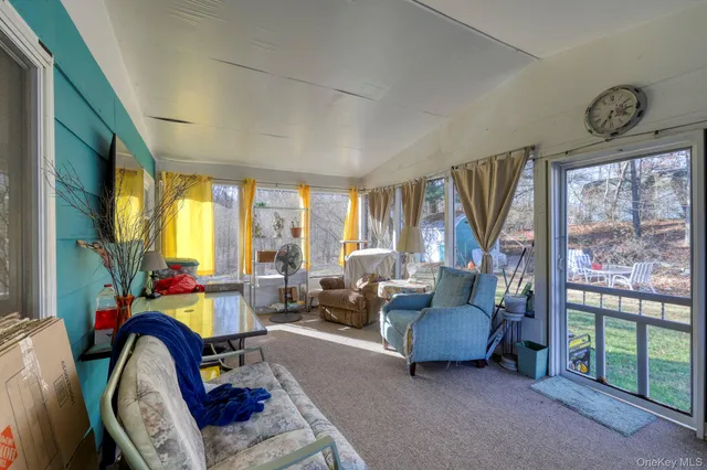 a bedroom with furniture and a large window