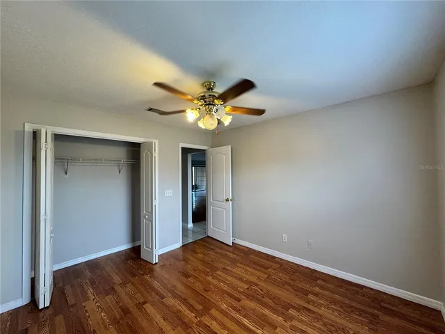 a view of an empty room and wooden floor