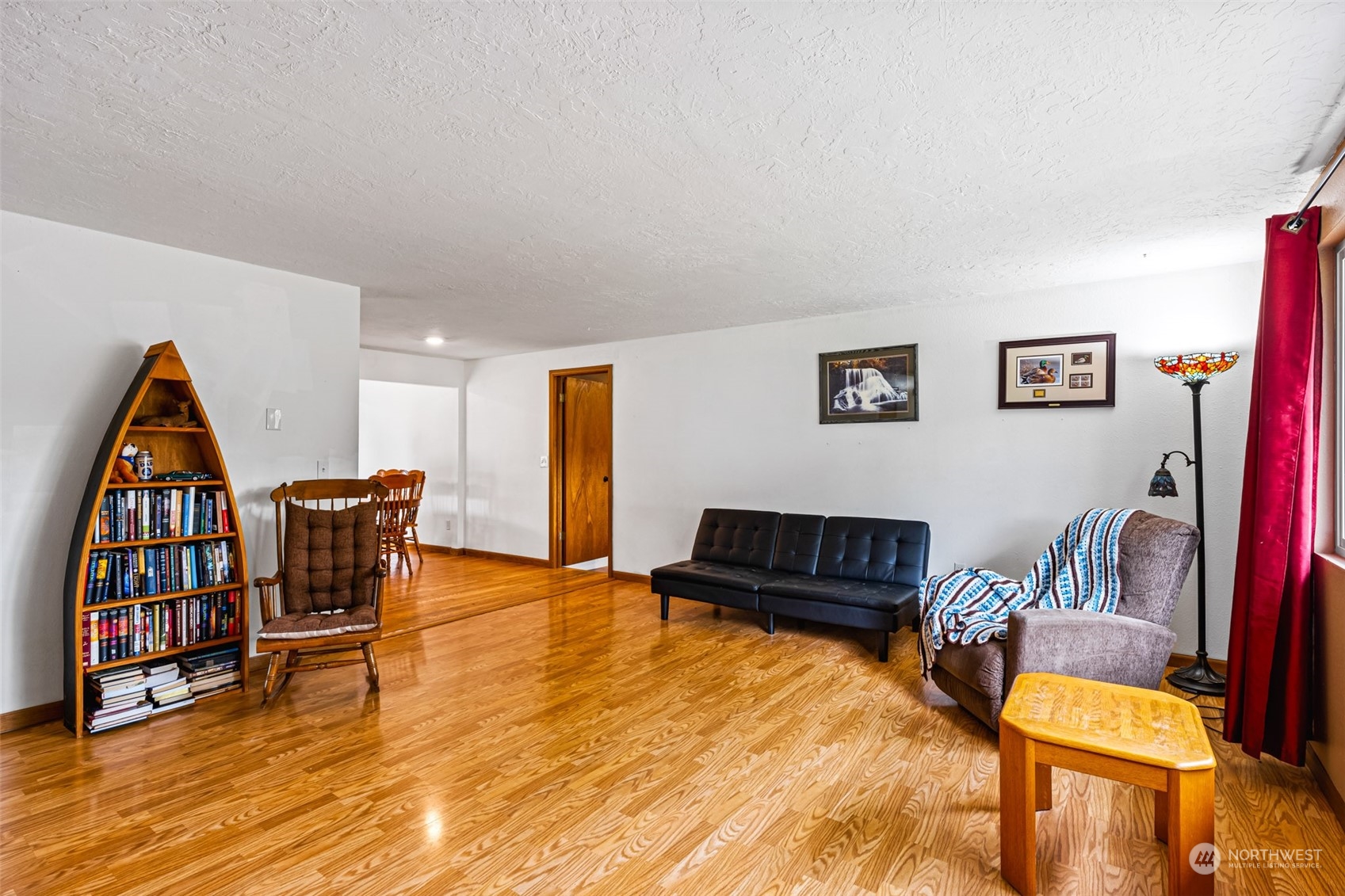 19131 Rosemary Street Southwest Rochester, WA 98579 - Photo 6 of 36 a living room with furniture and a wooden floor