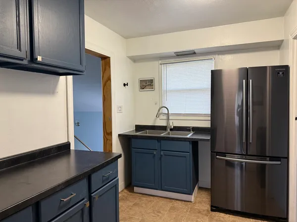 a kitchen with a refrigerator and a sink