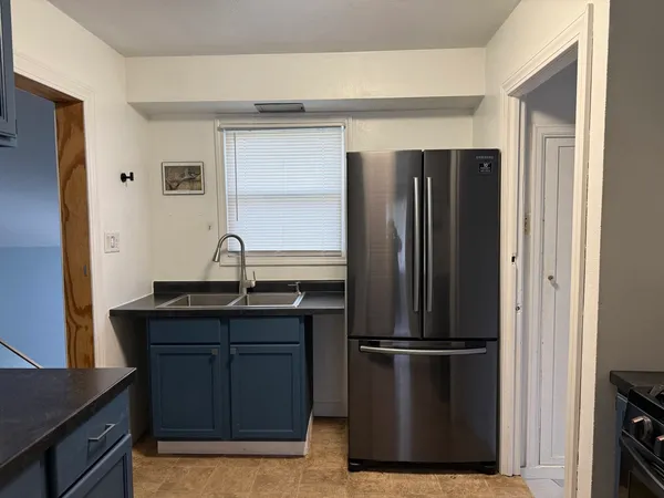 a kitchen with stainless steel appliances granite countertop a refrigerator and a sink